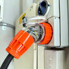Electric vehicle charging cable with black and orange connectors on a white background